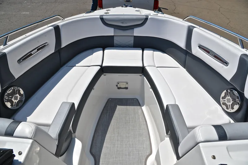 Slide: The Image of 2019 Chaparral 277 SSX boat interior with white and gray seating, featuring stainless steel accents. - 23
