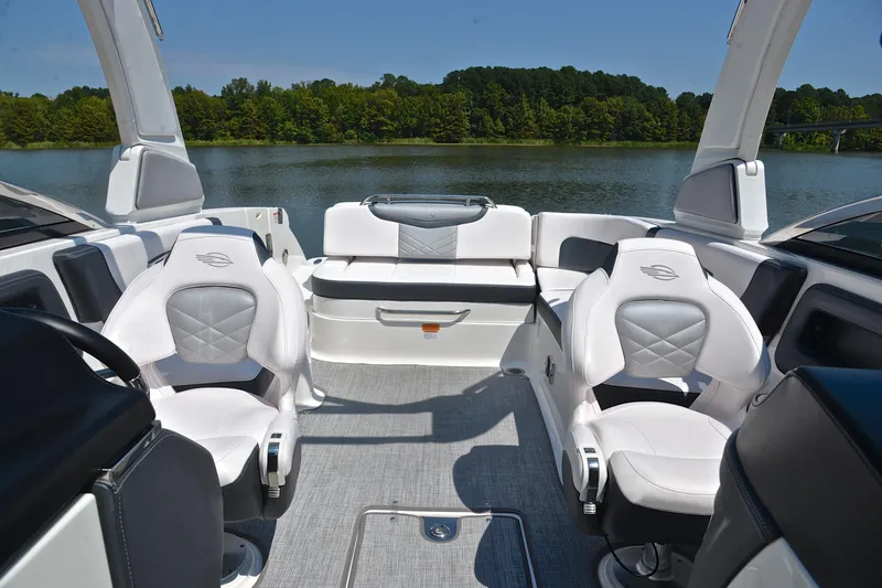 Slide: The Image of 2019 Chaparral 277 SSX boat interior with luxurious seating on a serene lake. - 24