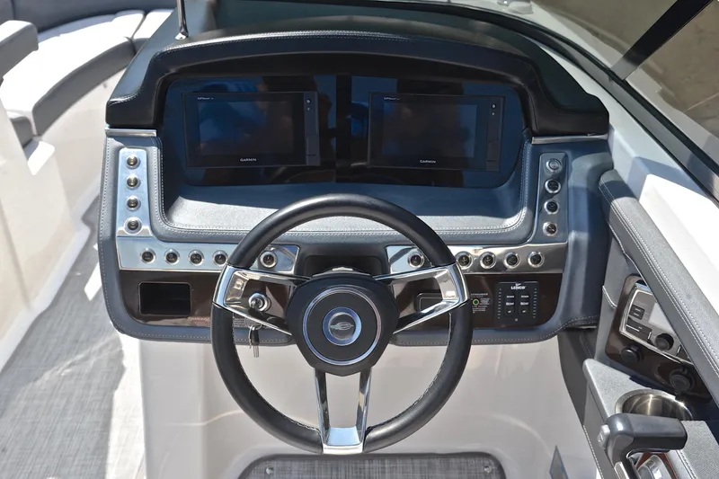 Slide: The Image of 2019 Chaparral 277 SSX boat dashboard with steering wheel and control panels. - 27
