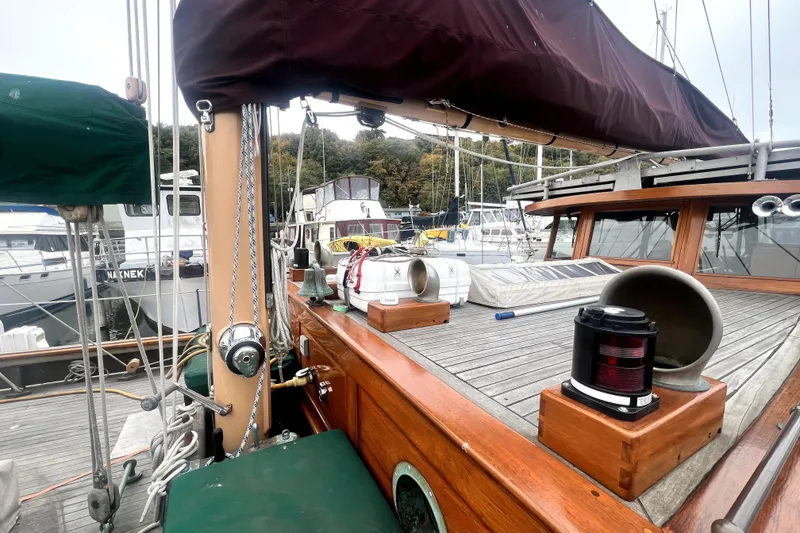 Slide: The Image of 1934 Pankey Schooner deck with wooden details and nautical equipment at marina. - 16