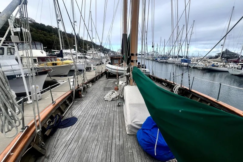 Slide: The Image of 1934 Pankey Schooner docked at marina, surrounded by sailboats and calm waters. - 18