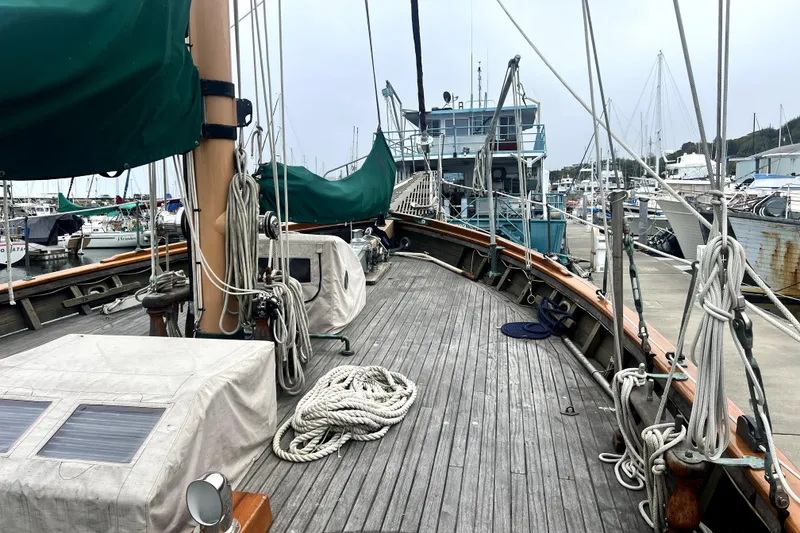 Slide: The Image of Vintage 1934 Pankey Schooner docked at marina, showcasing wooden deck and rigging. - 20