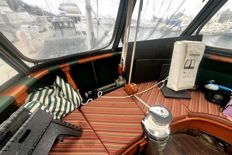 Slide: The Image of Interior of a 1934 Pankey Schooner with striped cushions and nautical equipment. - 21