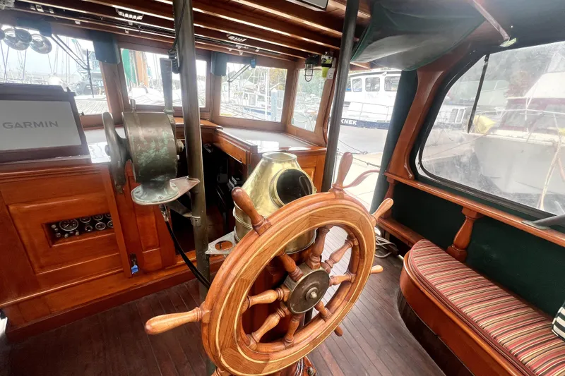 Slide: The Image of Interior of a 1934 Pankey Schooner with wooden steering wheel and vintage nautical instruments. - 23