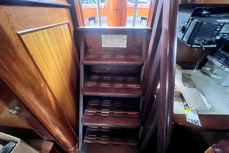 Slide: The Image of Wooden interior stairs of a 1934 Pankey Schooner, showcasing classic nautical craftsmanship. - 31