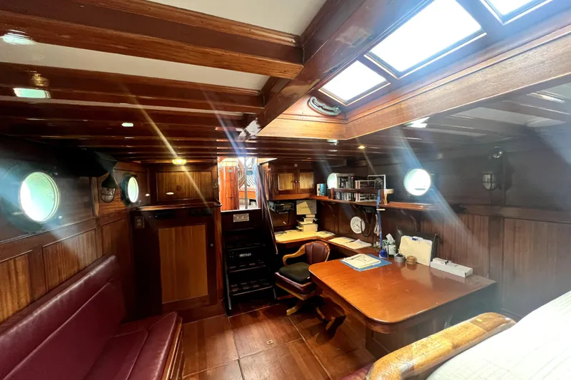 Slide: The Image of Interior of 1934 Pankey Schooner with wooden furnishings and porthole windows. - 32