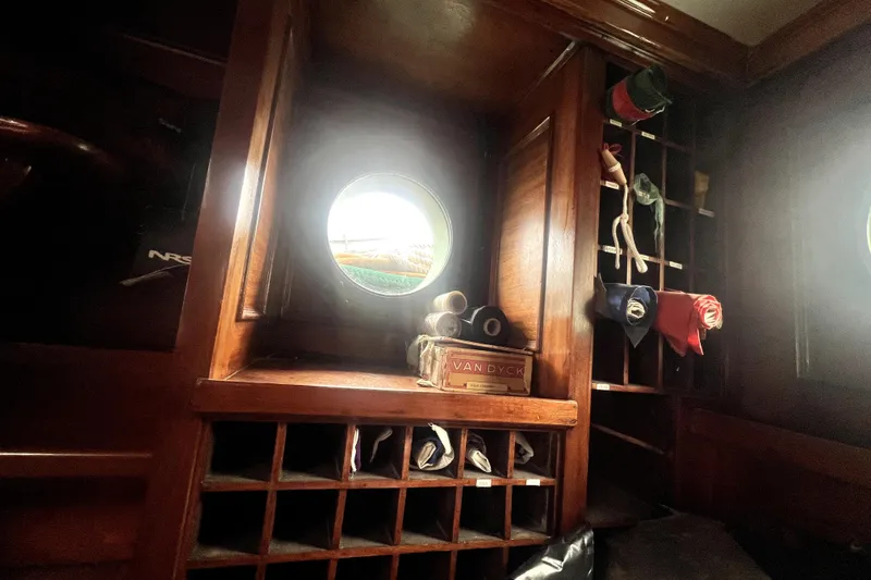 Slide: The Image of Interior of 1934 Pankey Schooner with porthole and wooden storage compartments. - 36