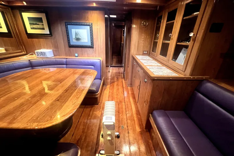 Slide: The Image of Luxurious wooden interior of a 1934 Pankey Schooner with elegant seating and framed artwork. - 38