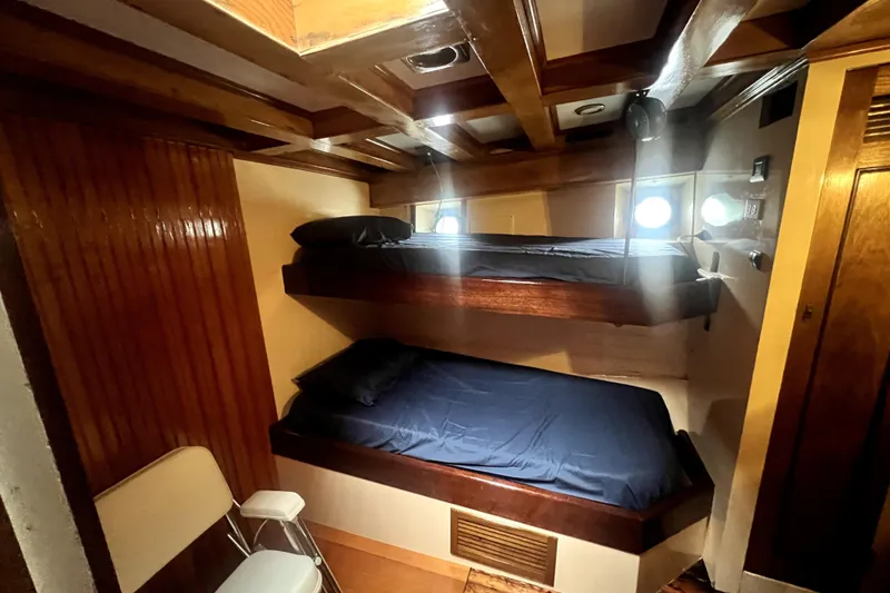 Slide: The Image of Interior of 1934 Pankey Schooner with wooden bunk beds and porthole windows. - 41