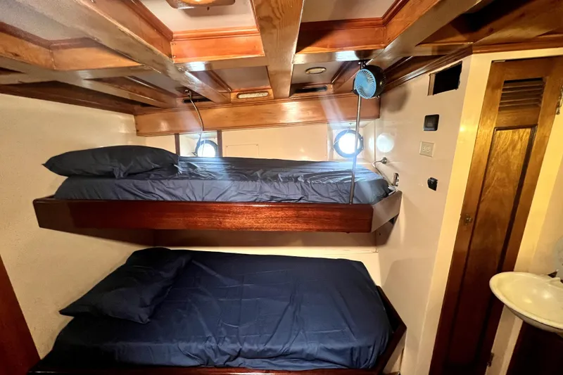 Slide: The Image of Interior of 1934 Pankey Schooner with wooden bunk beds and porthole windows. - 42