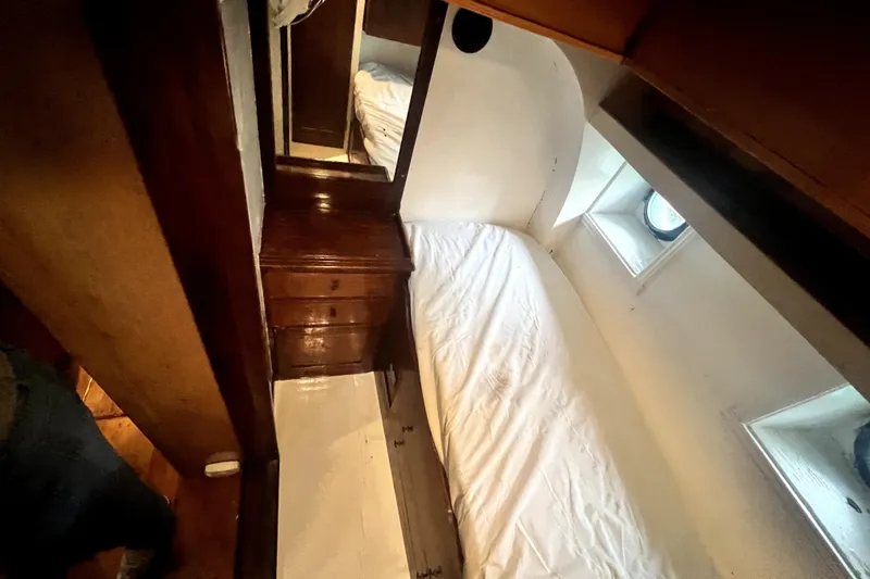 Slide: The Image of Cozy cabin interior of 1934 Pankey Schooner with wooden furnishings and porthole windows. - 45