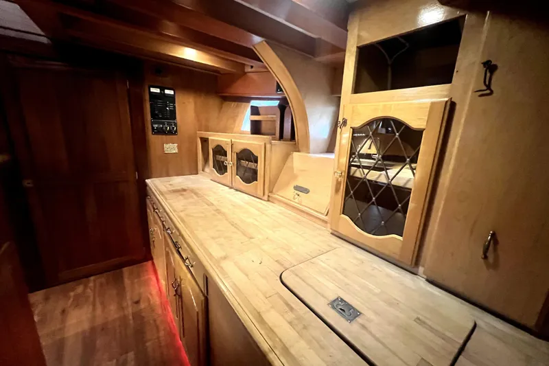 Slide: The Image of Interior of 1934 Pankey Schooner with wooden cabinetry and vintage design elements. - 50