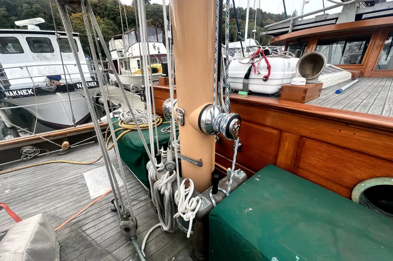 Slide: The Image of 1934 Pankey Schooner deck with ropes and winches in a marina setting. - 9