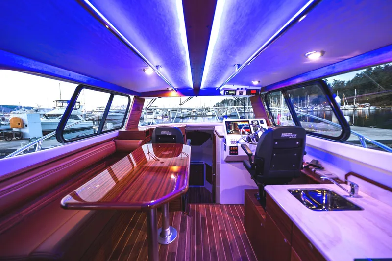 Slide: The Image of 2026 Ocean Sport 33 Cummins Shaft Drive cruising on open water under clear skies. - 5