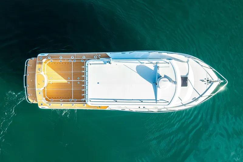 Slide: The Image of Luxurious interior of 2026 Ocean Sport 33 Cummins Shaft Drive boat with leather seating and wooden table. - 7