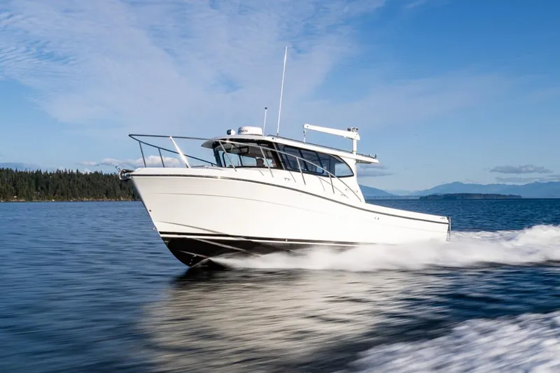 Slide: The Image of Interior of 2026 Ocean Sport 33 Cummins Shaft Drive boat with modern controls and navigation. - 8