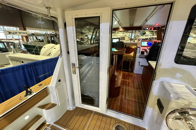 Slide: The Image of Interior view of 2026 Ocean Sport 33 Cummins Shaft Drive boat, showcasing cockpit and controls. - 9