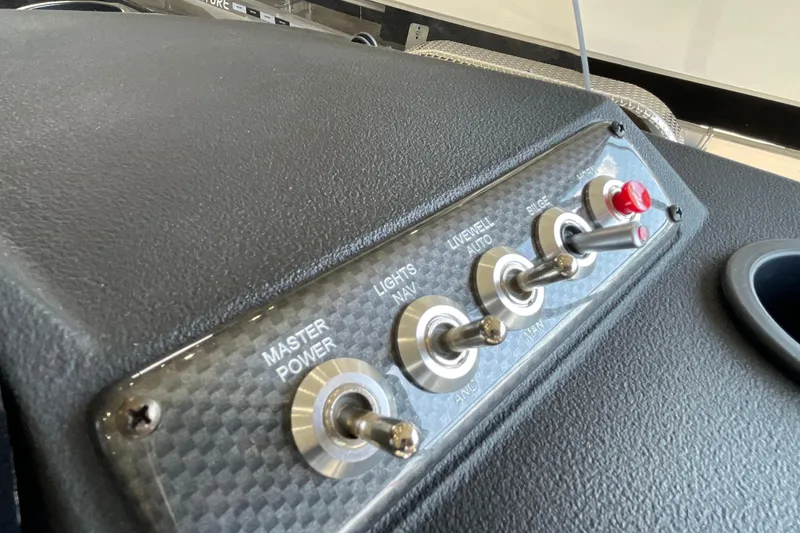 Slide: The Image of Control panel of 2026 Crestliner 1650 Fish Hawk SC boat with switches for power, lights, and bilge. - 10