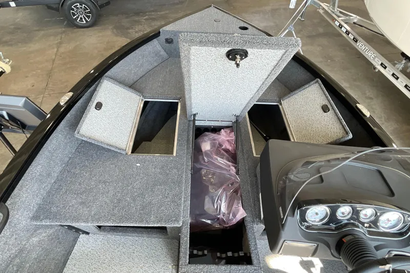Slide: The Image of 2026 Crestliner 1650 Fish Hawk SC boat interior with open storage compartments. - 12