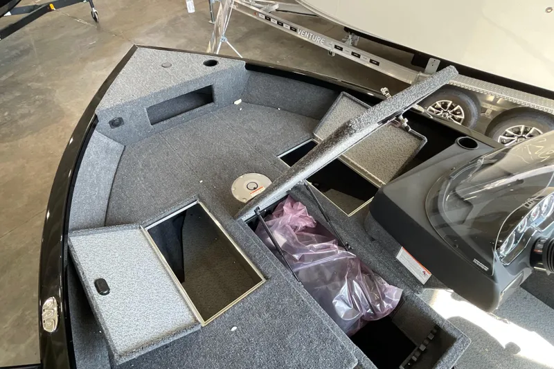 Slide: The Image of 2026 Crestliner 1650 Fish Hawk SC boat interior with storage compartments and console. - 13