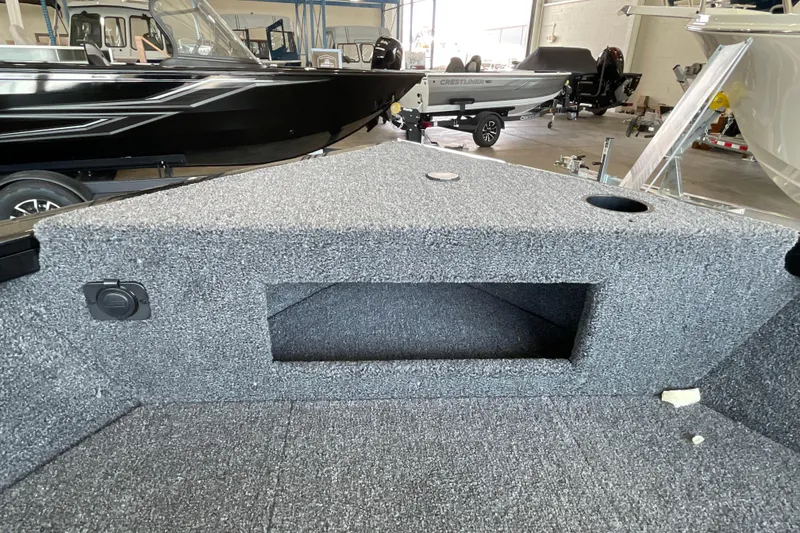 Slide: The Image of 2026 Crestliner 1650 Fish Hawk SC interior with storage compartment in showroom. - 14