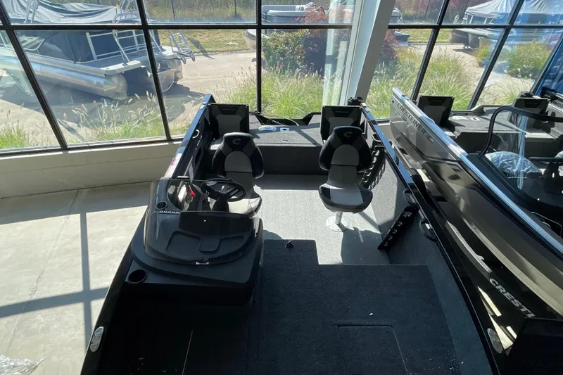 Slide: The Image of 2026 Crestliner 1650 Fish Hawk SC boat interior with seating and steering console. - 15