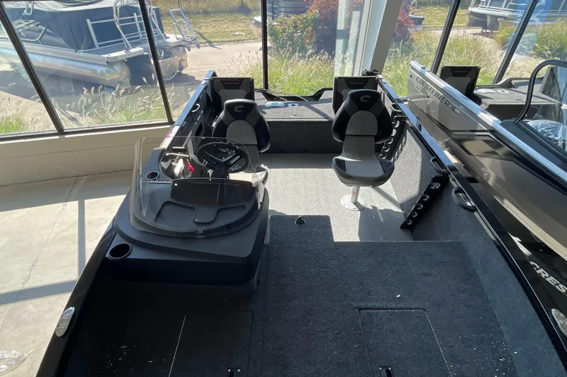 Slide: The Image of 2026 Crestliner 1650 Fish Hawk SC interior with dual seats and steering console. - 18