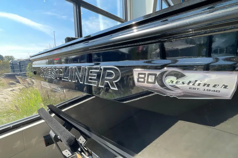 Slide: The Image of 2026 Crestliner 1650 Fish Hawk SC boat exterior with logo and anniversary badge. - 19