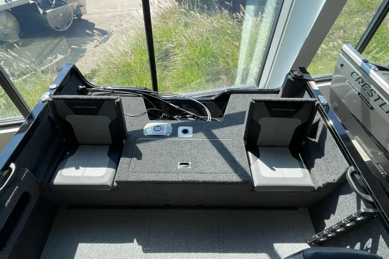 Slide: The Image of 2026 Crestliner 1650 Fish Hawk SC interior with dual seats and control panel. - 2