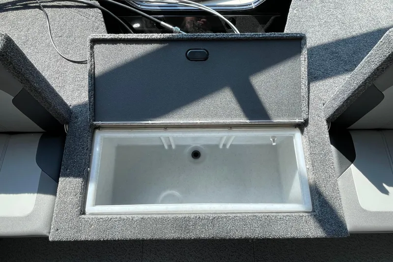 Slide: The Image of 2026 Crestliner 1650 Fish Hawk SC livewell, open lid, gray interior, sunlight. - 3