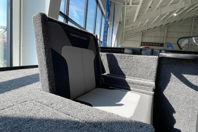 Slide: The Image of 2026 Crestliner 1650 Fish Hawk SC boat seat in a sunlit showroom. - 4