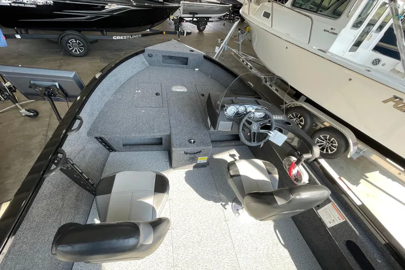 Slide: The Image of 2026 Crestliner 1650 Fish Hawk SC interior with dual seats and control console. - 6