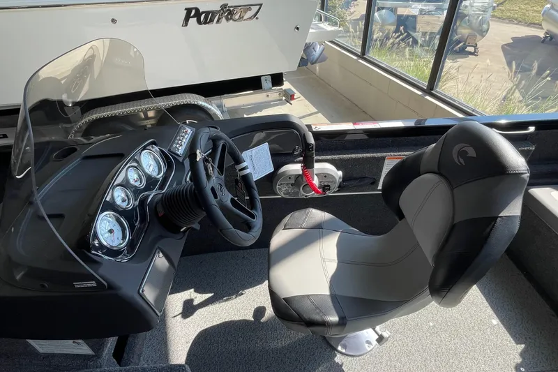 Slide: The Image of 2026 Crestliner 1650 Fish Hawk SC boat interior with steering console and captain's chair. - 7