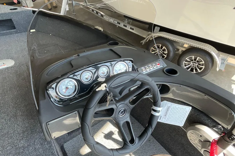 Slide: The Image of 2026 Crestliner 1650 Fish Hawk SC dashboard with steering wheel and instrument panel. - 8