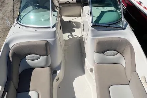 Slide: The Image of 2004 Sea Ray 220 Sundeck interior with dual seating and open cockpit design. - 10