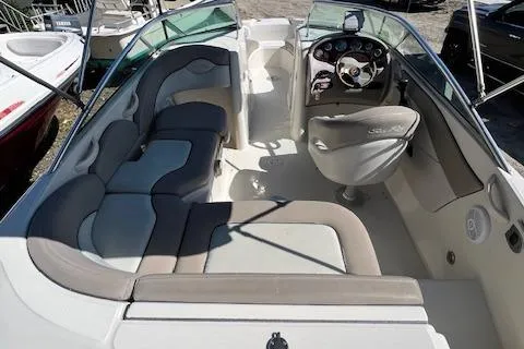 Slide: The Image of 2004 Sea Ray 220 Sundeck interior with seating and helm, showcasing spacious design. - 4