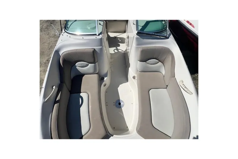 Slide: The Image of 2004 Sea Ray 220 Sundeck boat interior with beige seating and open deck layout. - 9