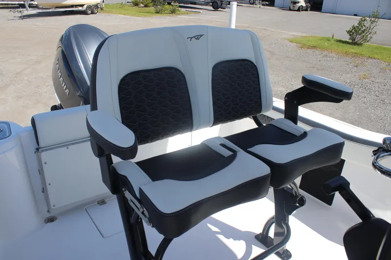 Slide: The Image of 2026 Tidewater 220 CC Adventure boat seats with armrests, featuring a Yamaha engine in the background. - 13