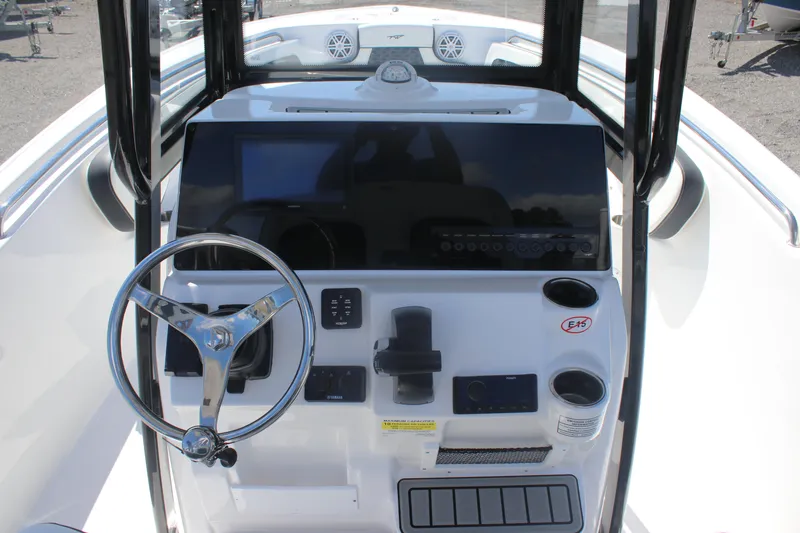 Slide: The Image of 2026 Tidewater 220 CC Adventure boat console with steering wheel and controls. - 15