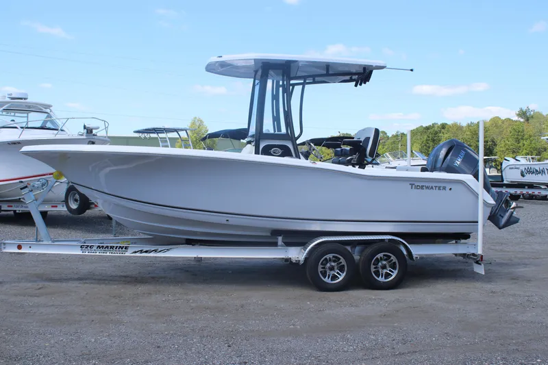 Slide: The Image of 2026 Tidewater 220 CC Adventure boat on trailer, parked outdoors under clear sky. - 4