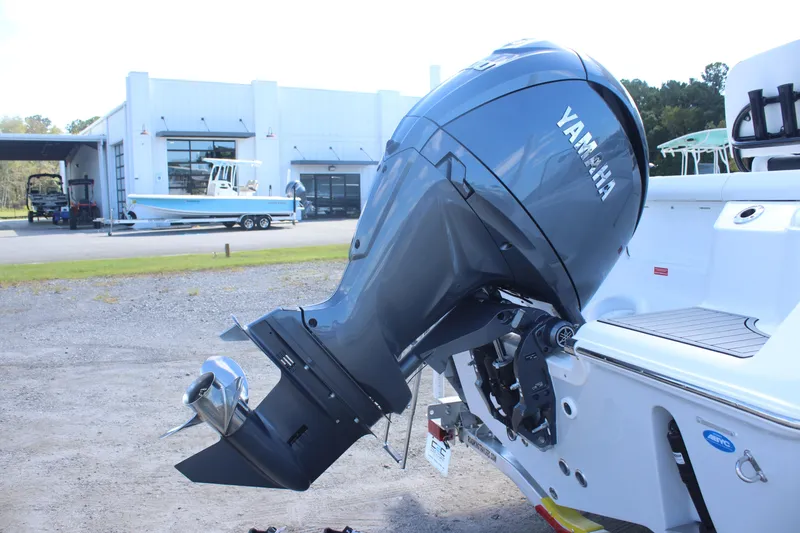 Slide: The Image of 2026 Tidewater 220 CC Adventure with Yamaha outboard motor at a marina. - 5