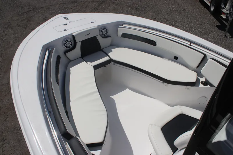 Slide: The Image of 2026 Tidewater 220 CC Adventure boat interior with cushioned seating and speakers. - 7