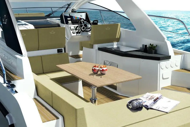 Slide: The Image of Luxurious 2026 Sealine S335V yacht interior with seating, table, and helm, set against ocean backdrop. - 10