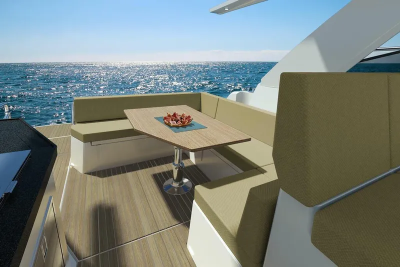 Slide: The Image of 2026 Sealine S335V yacht deck with seating and table, overlooking the ocean. - 13