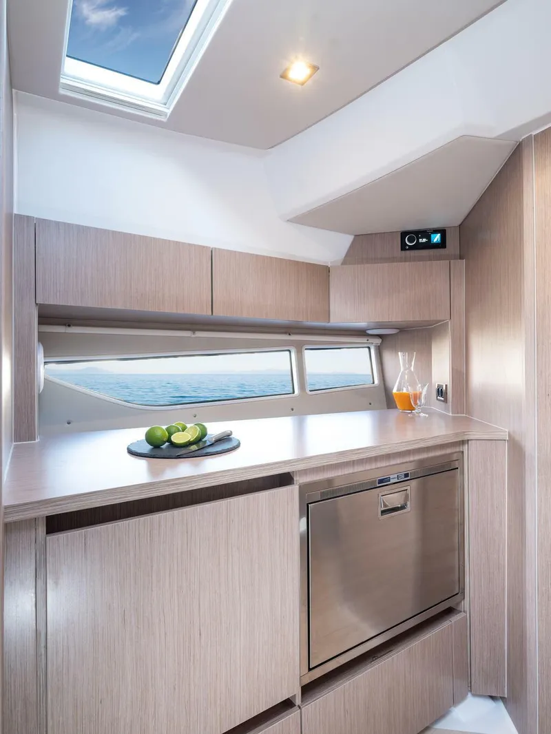 Slide: The Image of 2026 Sealine S335V yacht interior kitchen with modern design and ocean view. - 16