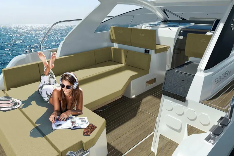 Slide: The Image of 2026 Sealine S335V yacht interior with woman relaxing, reading, and listening to music. - 9