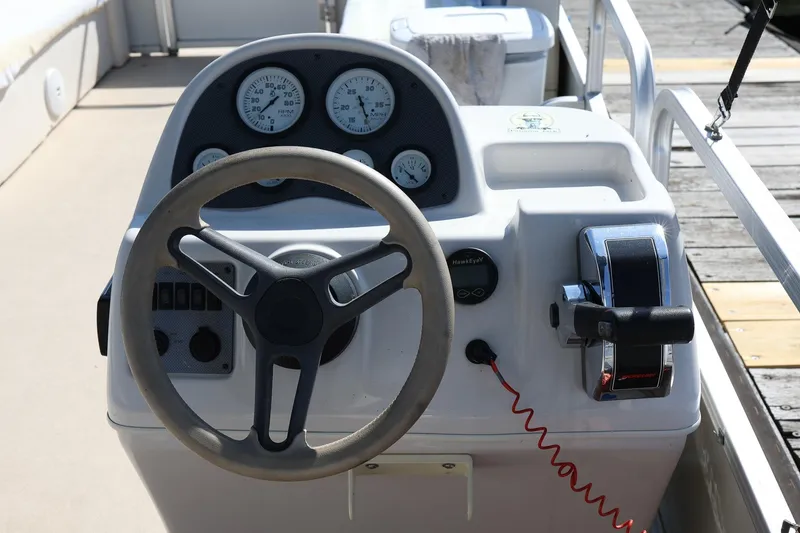Slide: The Image of 2007 Sundancer Pontoons 24LX steering console with gauges and controls. - 10