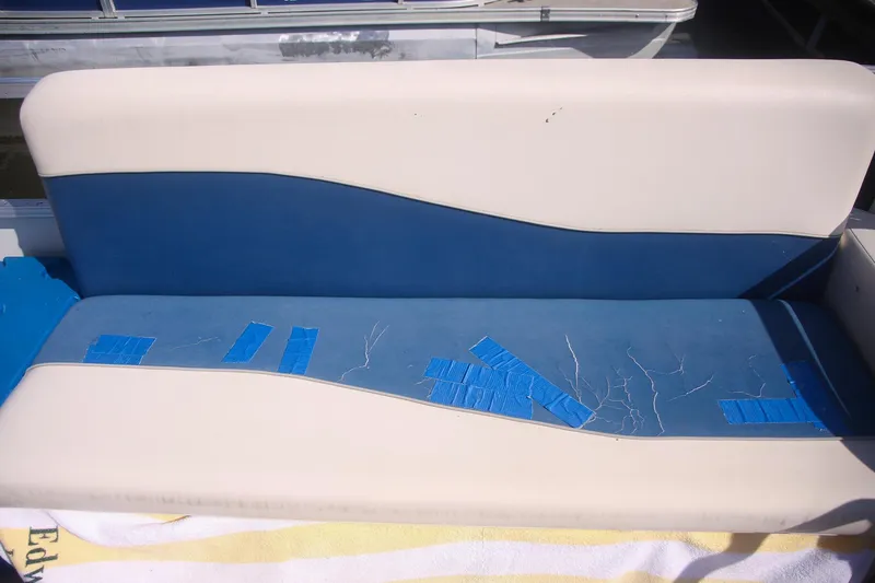 Slide: The Image of Worn boat seat with blue tape repairs on a 2007 Sundancer Pontoons 24LX. - 11