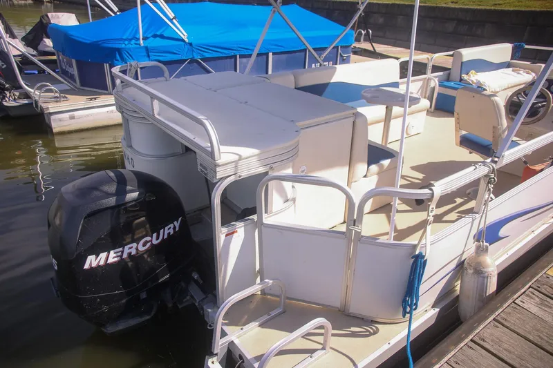 Slide: The Image of 2007 Sundancer Pontoons 24LX with Mercury outboard engine docked at marina. - 13