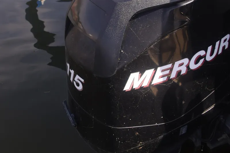 Slide: The Image of Mercury 115 outboard motor on 2007 Sundancer Pontoons 24LX, reflecting on water. - 14